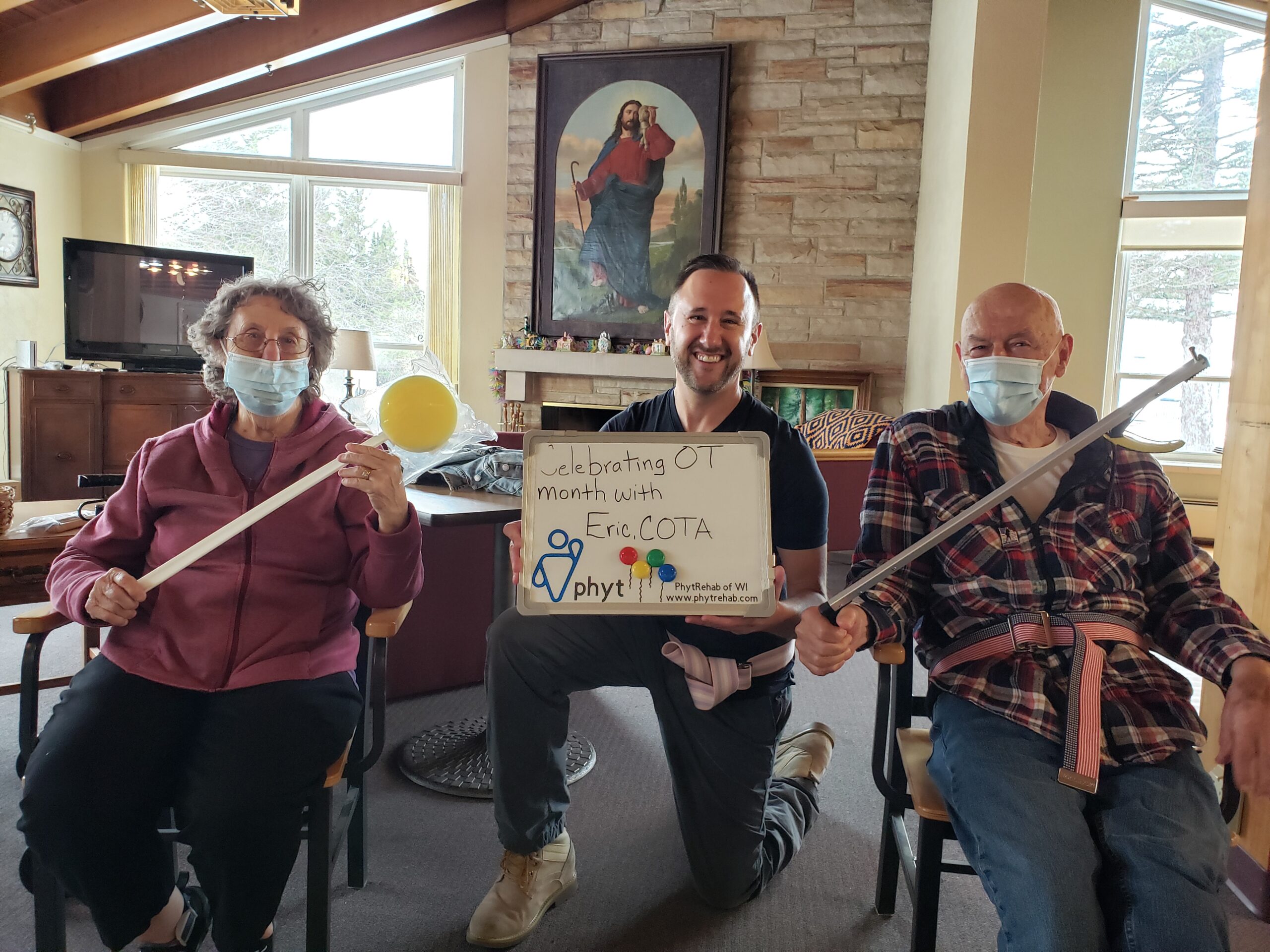 Three individuals wearing face masks, each holding a sign, promoting awareness and safety in a public setting.