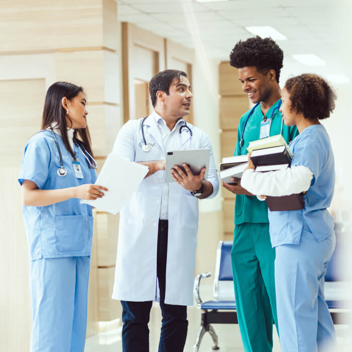 A group of doctors engaged in conversation, sharing insights and discussing medical matters in a professional setting.