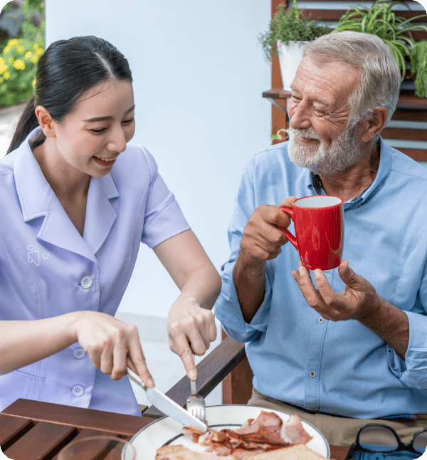 A nurse assisting an elderly man with daily activities at his home.